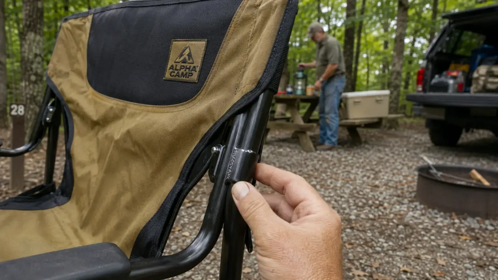 Close-up of a hand checking the weld at the leg joint of a heavy duty camping chair